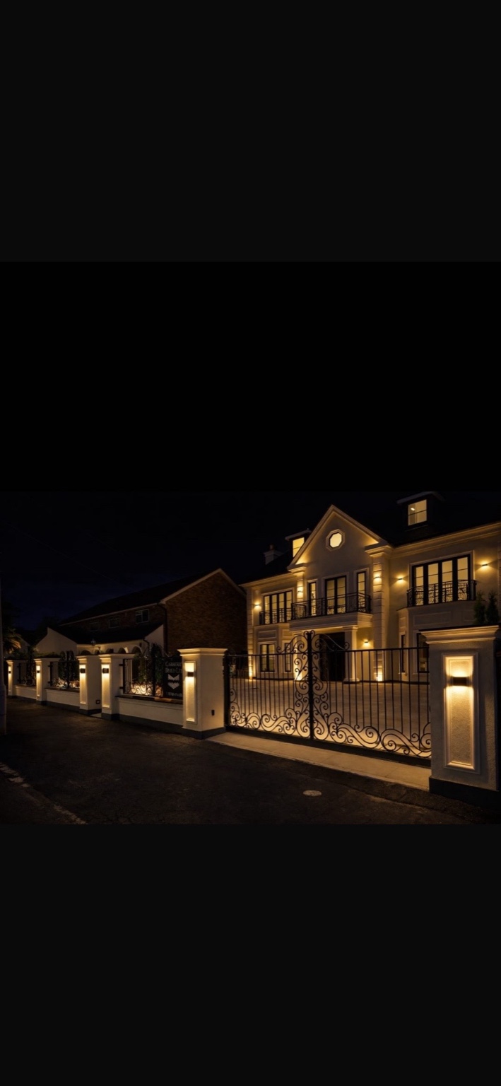 Large front entrance and gates at night